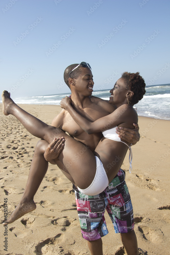 Black man hold his girlfriend his arms