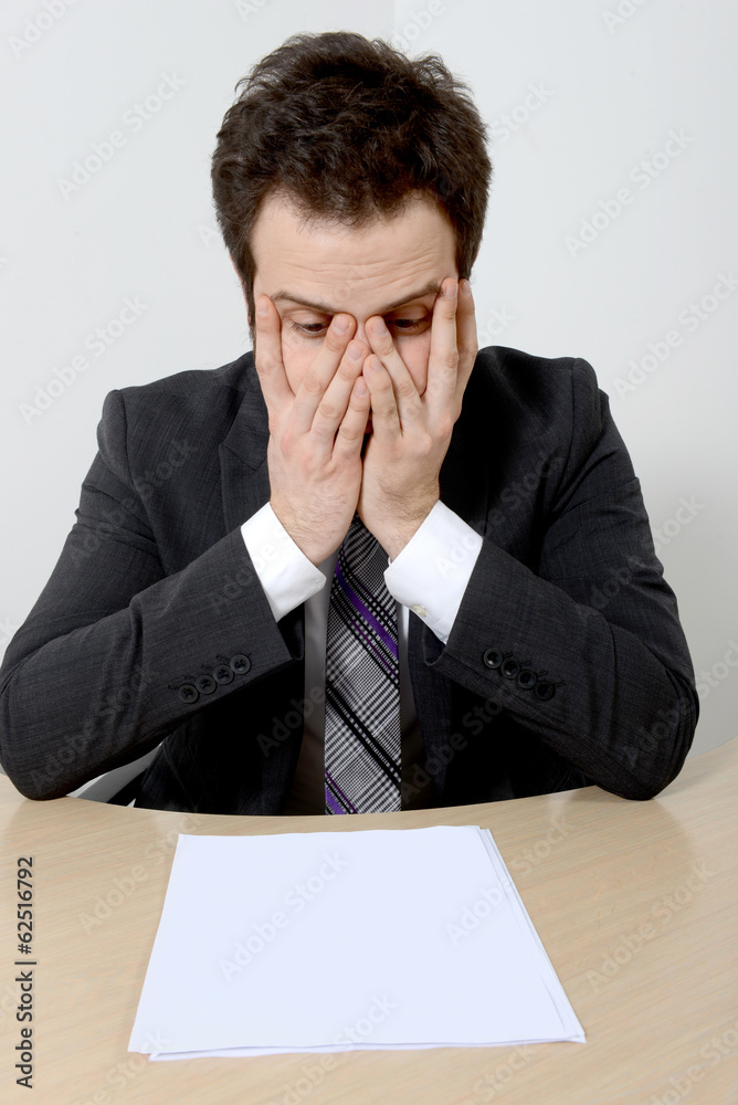 Worried young businessman with blank paper Worried young businessman with blank paper