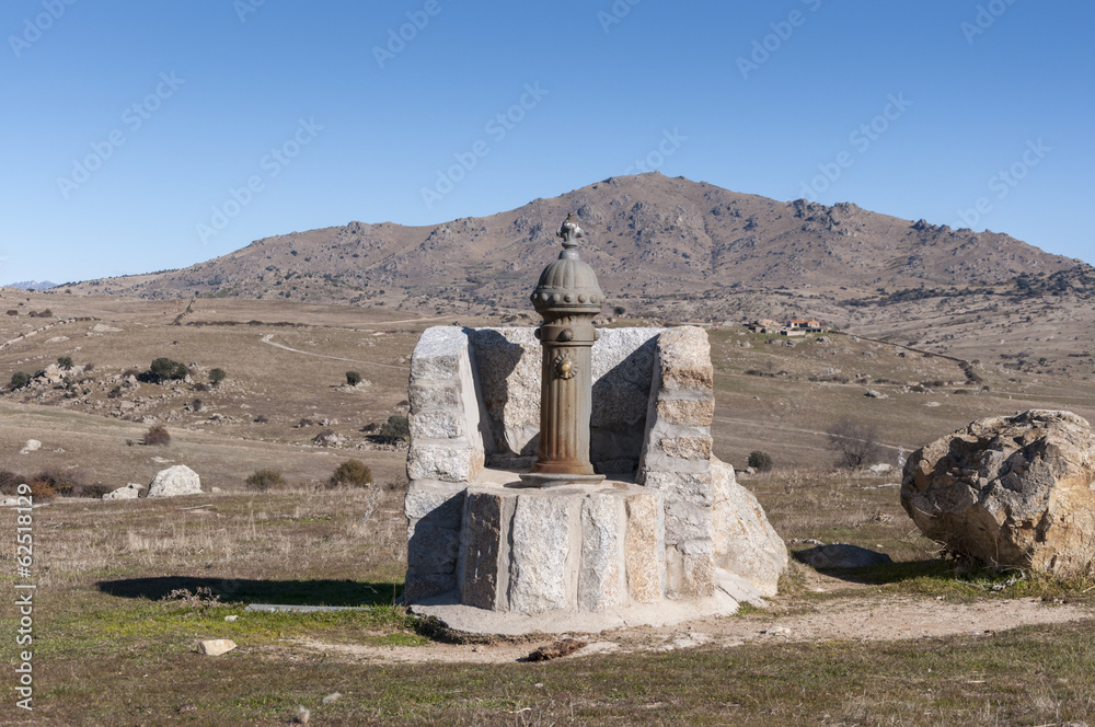 Fototapeta premium Rustic fountain in the field
