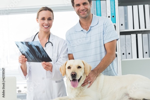 Pet owner and veterinarian with Xray of dog