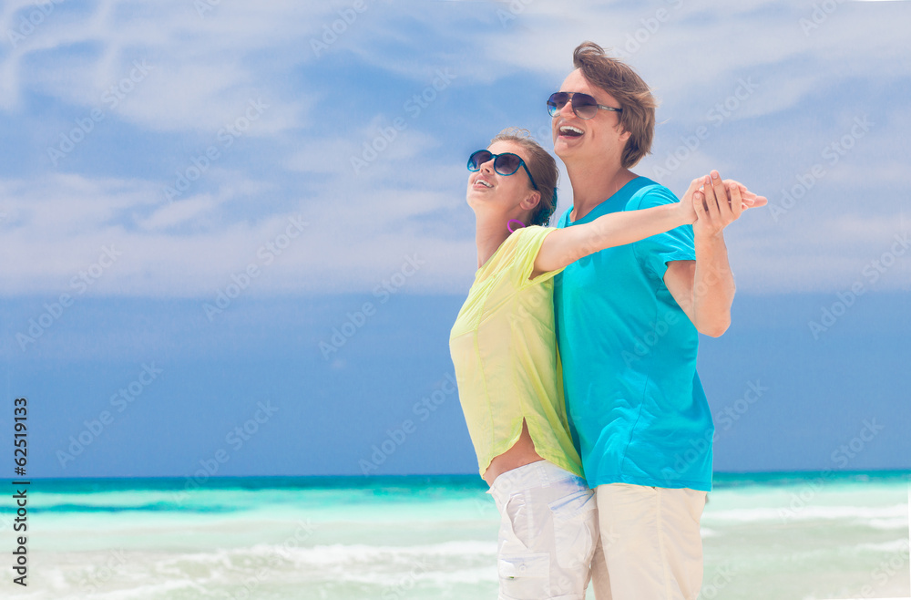 front view happy young couple on beach front view happy young couple on beach