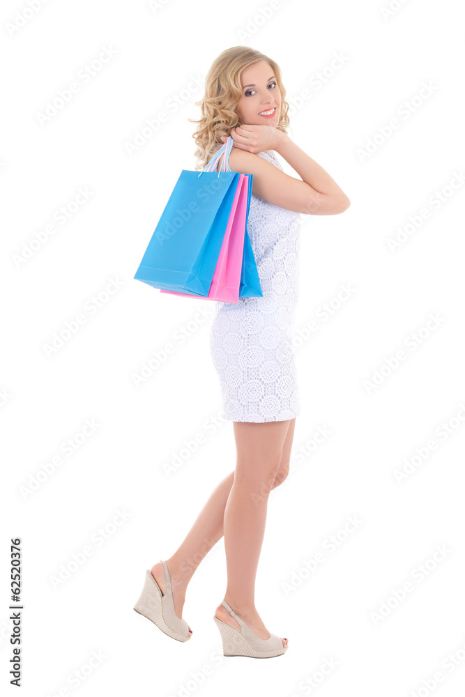 young woman in white dress with shopping bags isolated on white