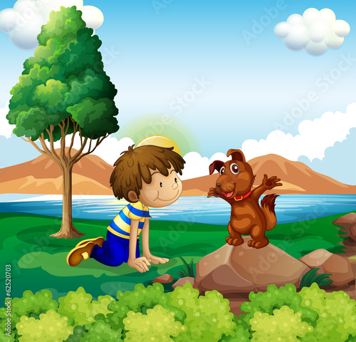 A young boy and his pet near the lake