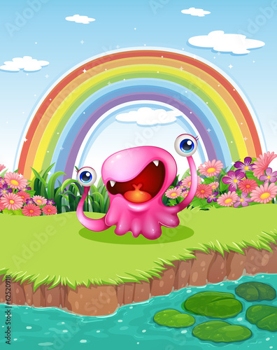 A monster at the pond with a rainbow in the sky