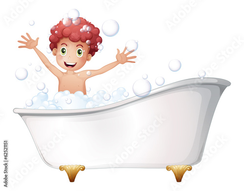 A bathtub with a young boy playing