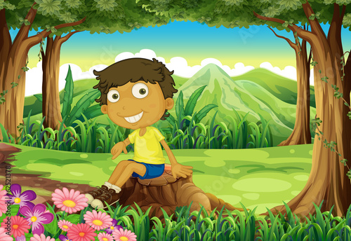 A smiling child sitting above the stump