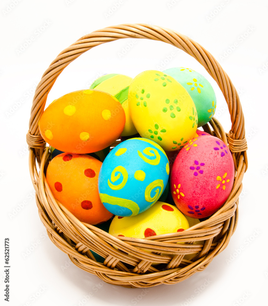 Colorful handmade easter eggs in the basket isolated