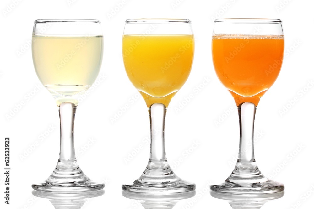 Tropical juices in glasses isolated on white Tropical juices in glasses isolated on white