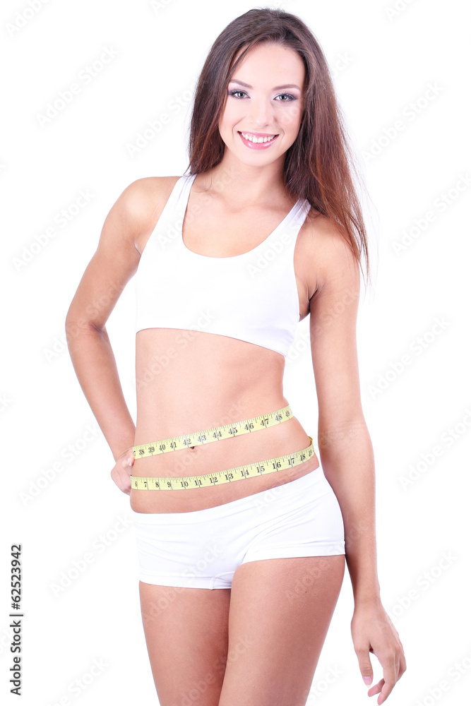 Obraz premium Beautiful young woman measuring her body with tape isolated