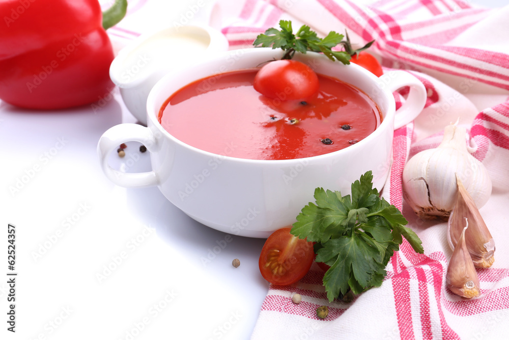 Tasty tomato soup and vegetables, isolated on white Tasty tomato soup and vegetables, isolated on white