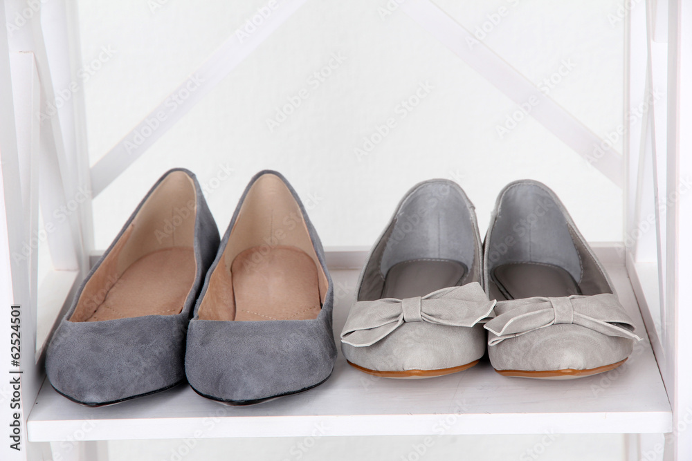 Beautiful female shoes on wooden shelf Beautiful female shoes on wooden shelf