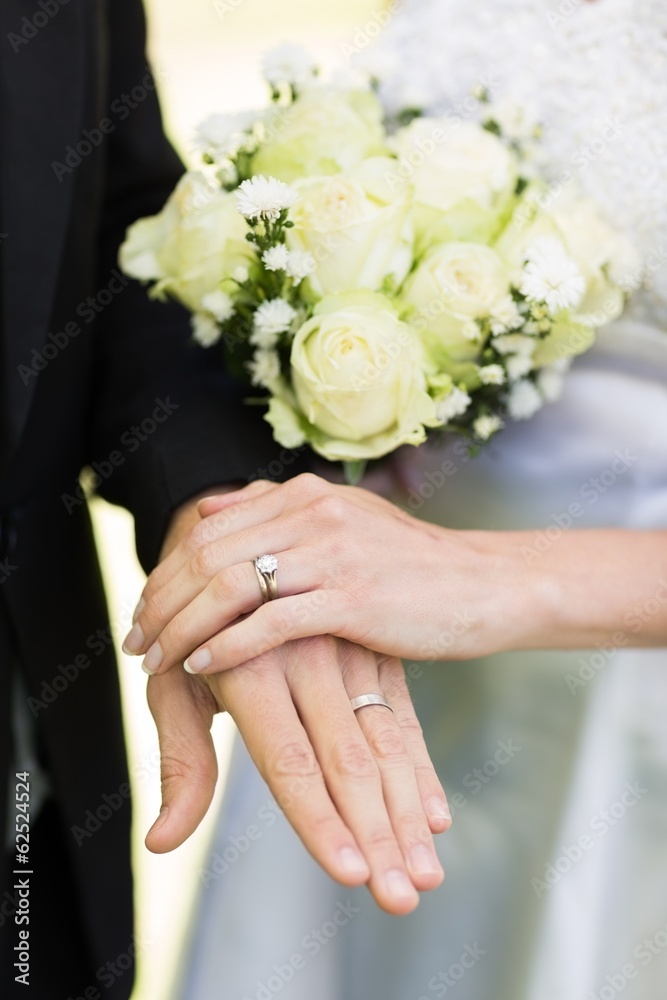 Bride and groom showing wedding rings Bride and groom showing wedding rings