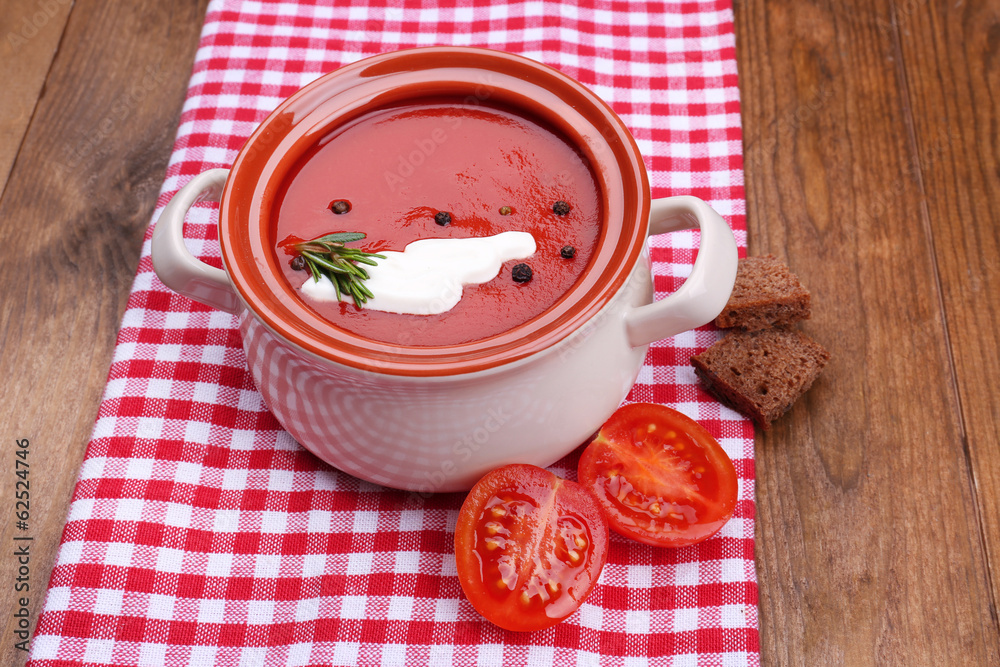 Tasty tomato soup on wooden table Tasty tomato soup on wooden table