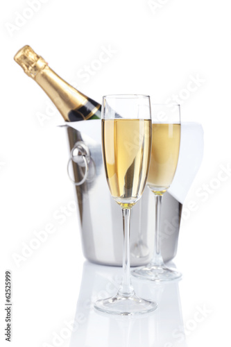 Glasses of champagne in pail, isolated on white