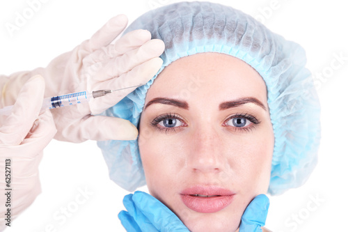Woman in beauty clinic getting botox injection, isolated