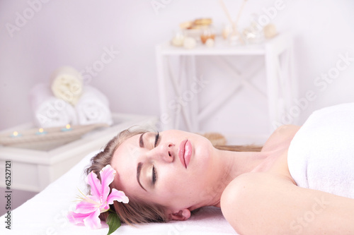 Beautiful young woman having relax in spa salon, close up