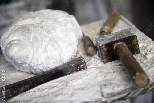 Photos alabaster stone and tools for working stone hammer chisel