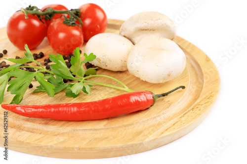 Fresh vegetables on wooden platter.