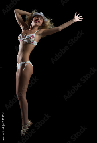 woman in bikini and hat dancing