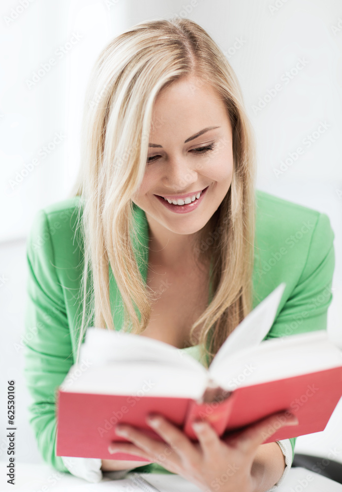 smiling young woman reading book at school smiling young woman reading book at school