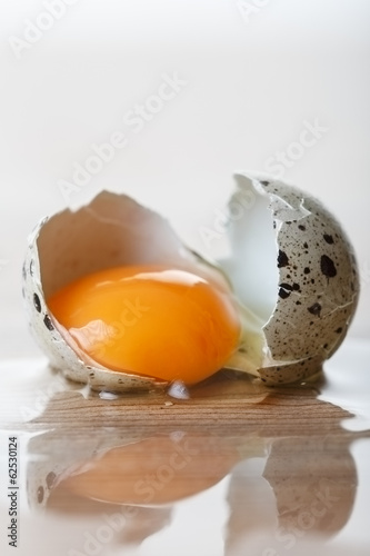 Quail egg broken on the table