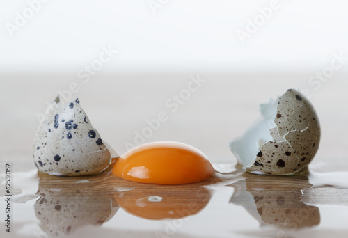 Quail egg broken on the table