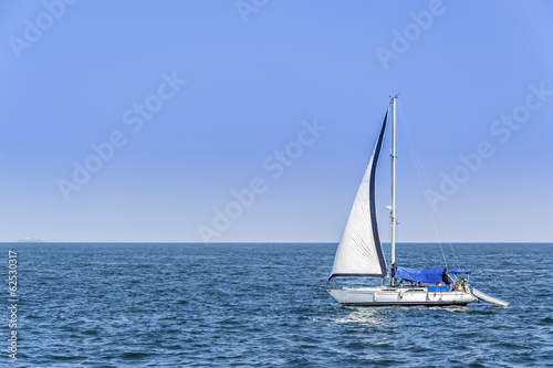 Alone sailboat in the Mediterranean Sea
