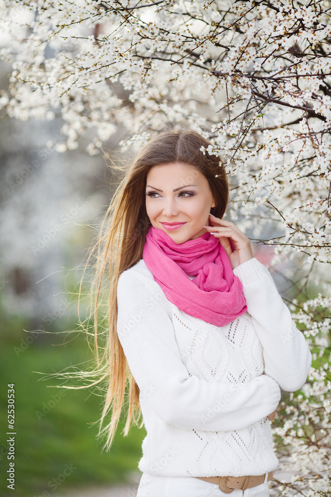 portrait of young brunette in the spring blooming garden portrait of young brunette in the spring blooming garden