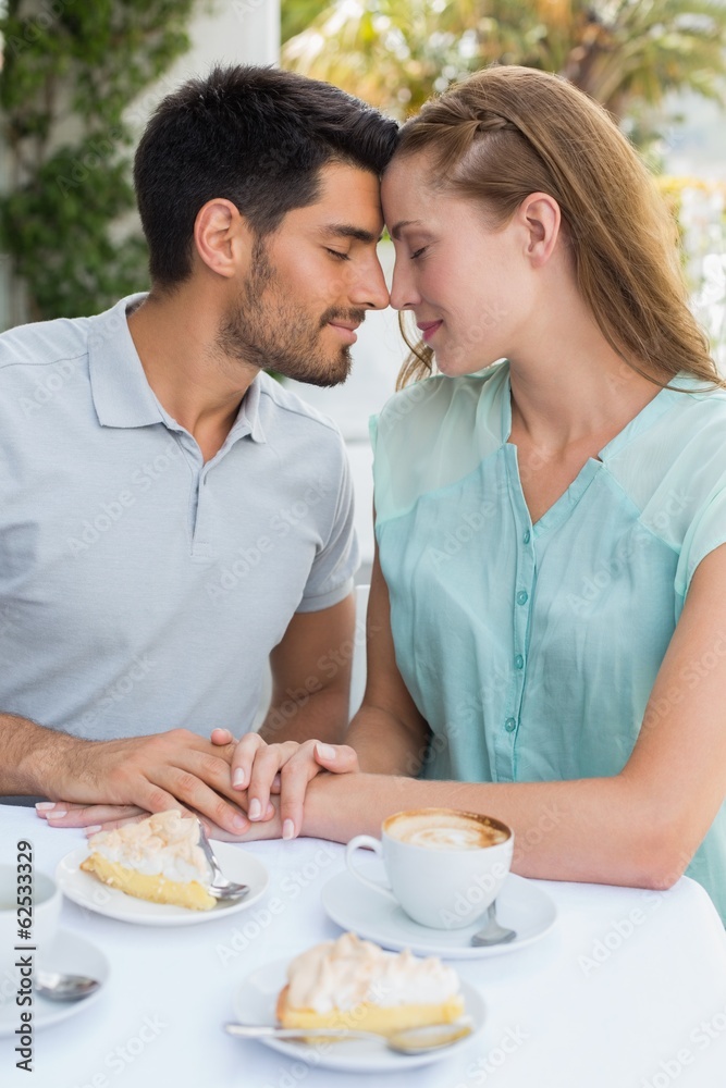 Couple with eyes closed at coffee shop