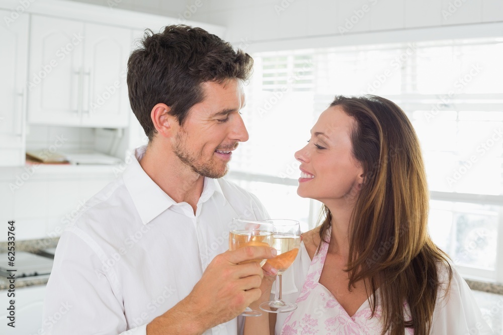Loving couple toasting wine glasses at home Loving couple toasting wine glasses at home