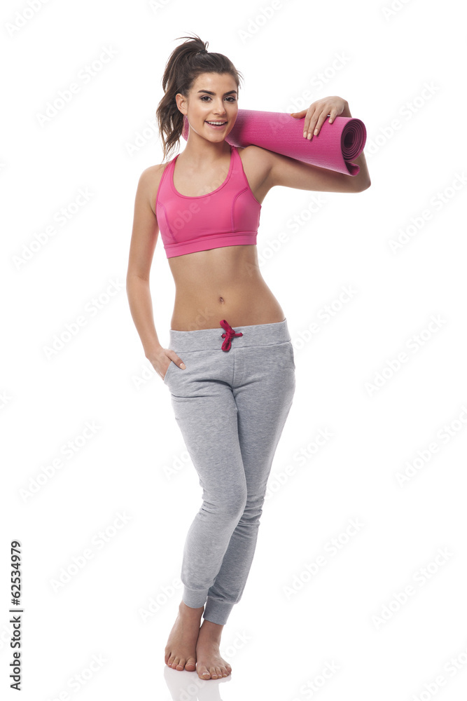Young attractive woman with exercise mat Young attractive woman with exercise mat