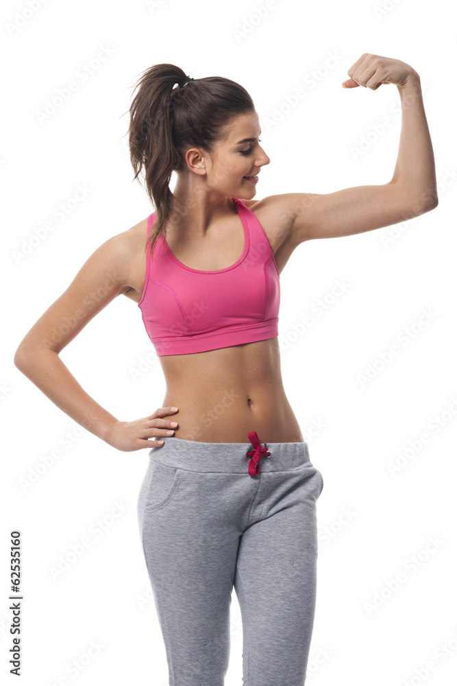 Beautiful woman checking effect of workout Beautiful woman checking effect of workout