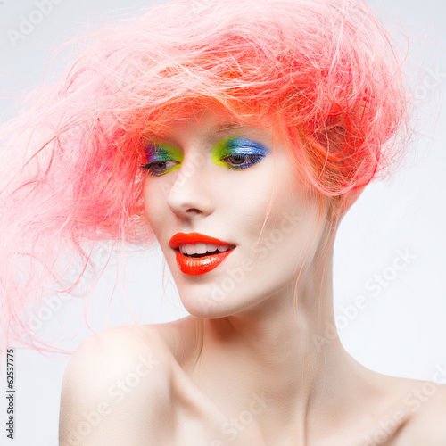 Portrait of beautiful girl with pink hair on a white background