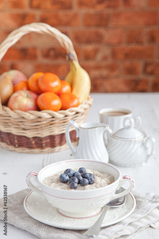 Healthy breakfast: oats porridge with coffee on the table