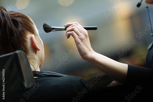 Young girl during makeup process