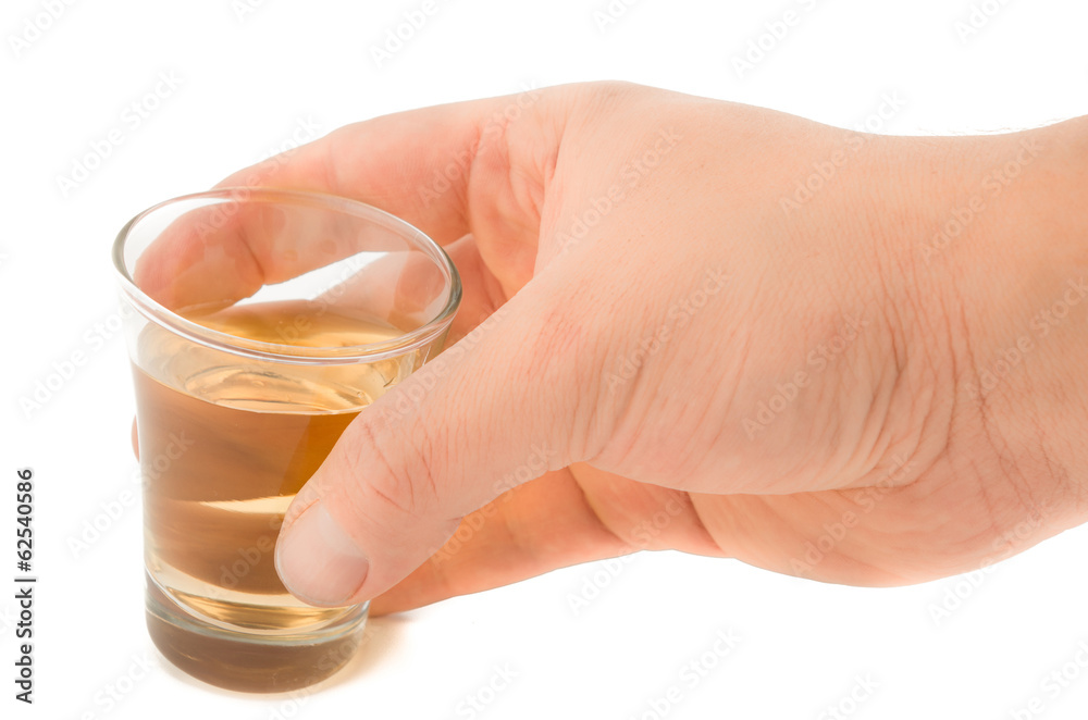 Man's hand holding a glass with tekila, tequila Man's hand holding a glass with tekila, tequila