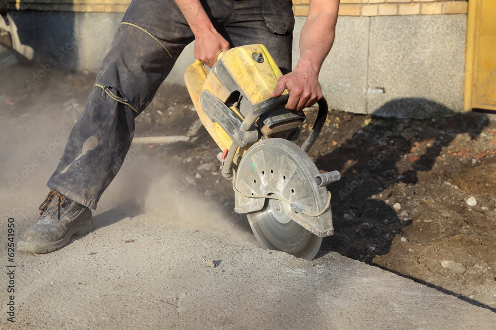 Construction site, asphalt or concrete cutting with saw blade Construction site, asphalt or concrete cutting with saw blade