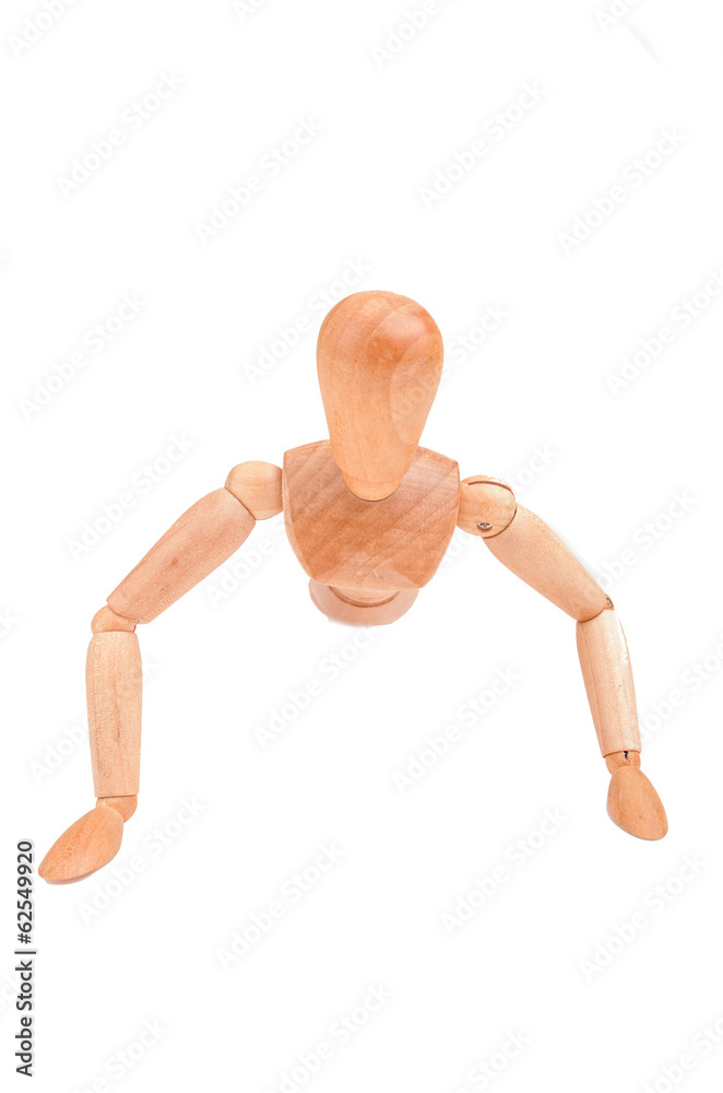 Jointed wooden mannequin doing push-ups isolated on white Jointed wooden mannequin doing push-ups isolated on white