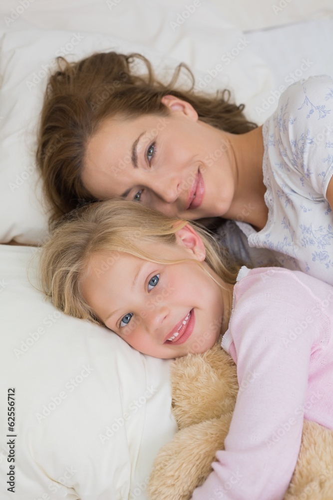 Girl and mother with stuffed toy resting in bed Girl and mother with stuffed toy resting in bed