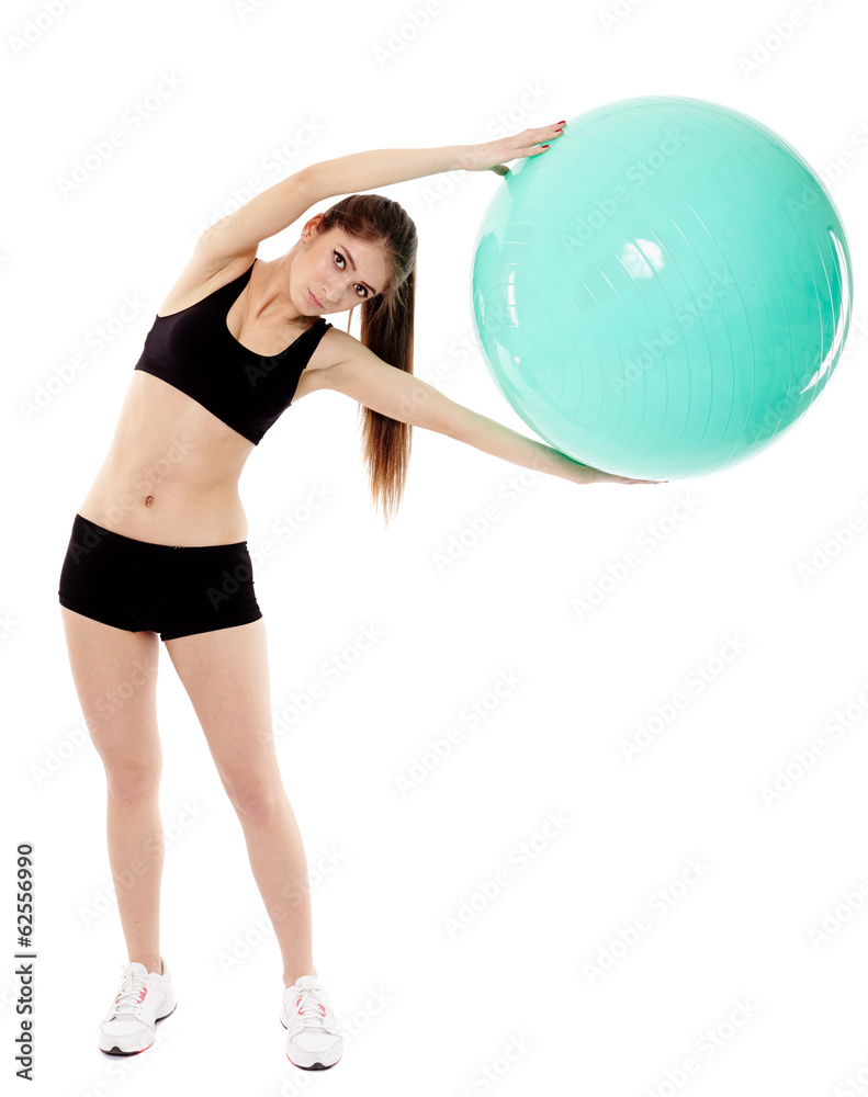 Athletic woman holding a ball and doing stretching Athletic woman holding a ball and doing stretching