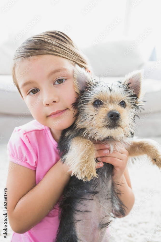 Little girl holding her yorkshire terrier puppy Little girl holding her yorkshire terrier puppy