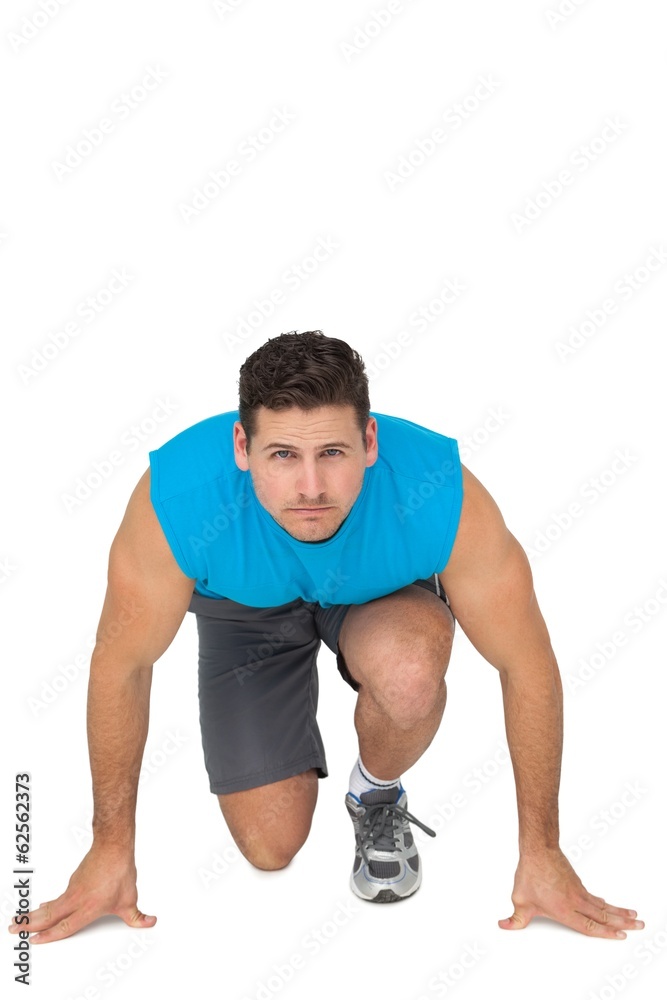 Portrait of a young sporty man in running stance Portrait of a young sporty man in running stance
