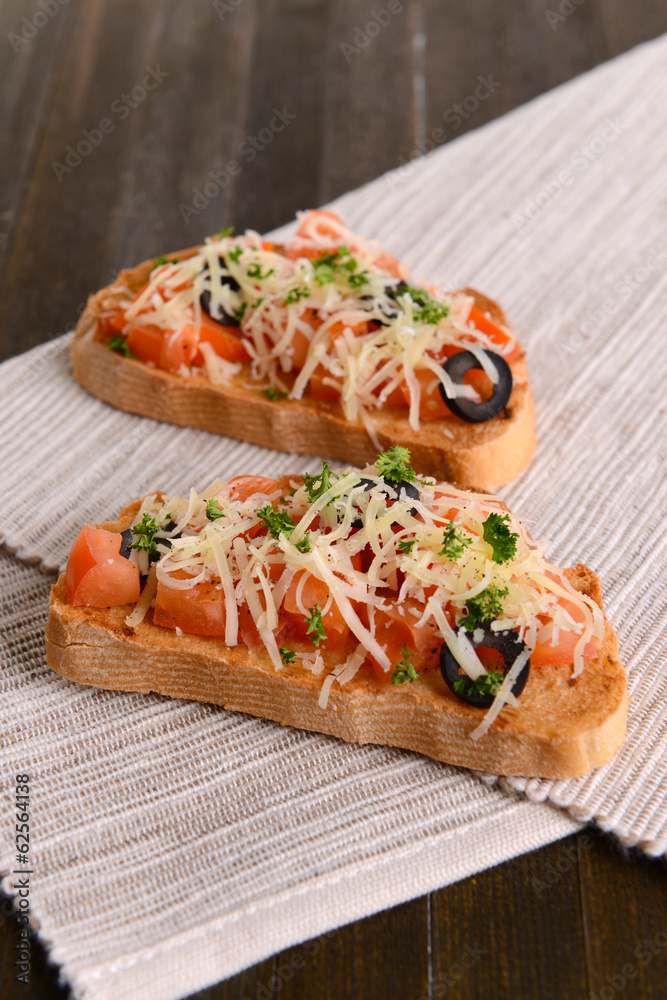 Delicious bruschetta with tomatoes on table close-up Delicious bruschetta with tomatoes on table close-up