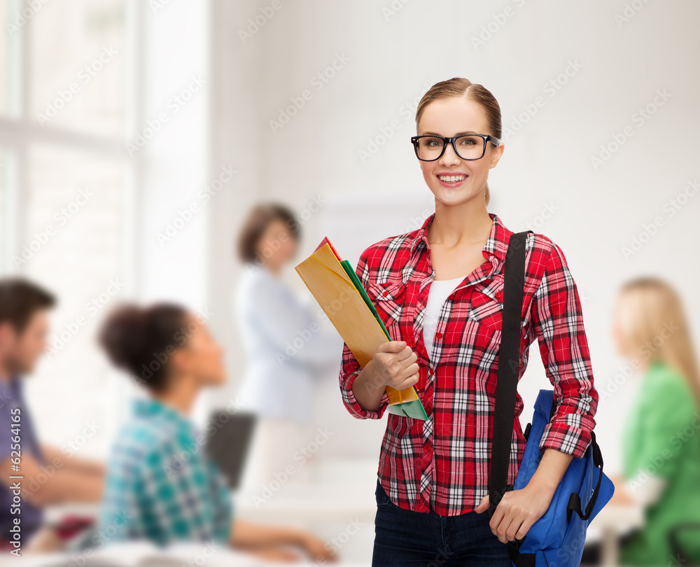 female student in eyeglasses with bag and folders