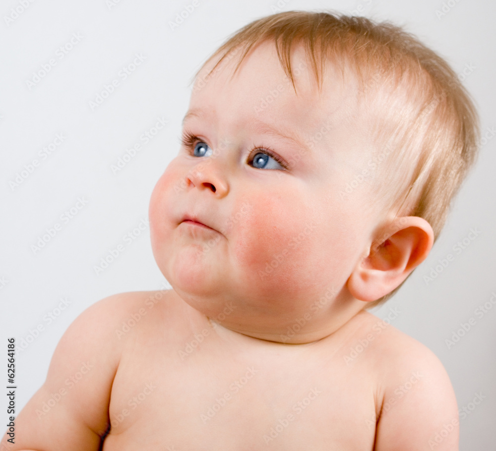 Serious infant boy on a grey background Serious infant boy on a grey background