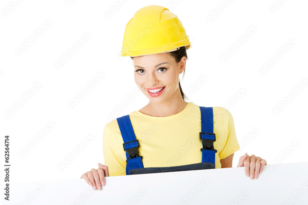 Construction worker woman holding blank board. Construction worker woman holding blank board.