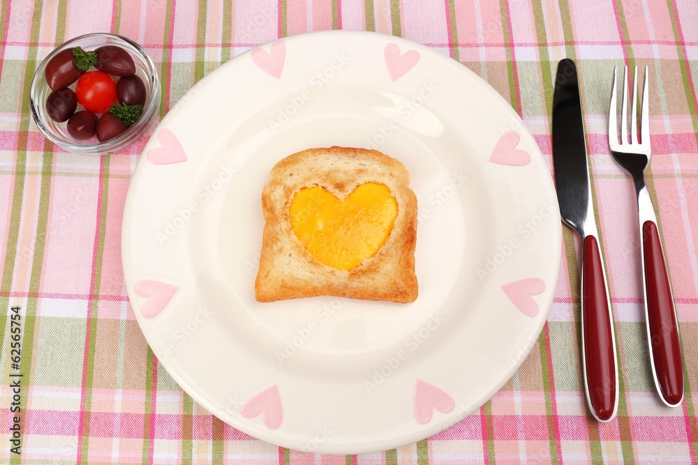 Scrambled eggs with bread on plate, on color napkin Scrambled eggs with bread on plate, on color napkin
