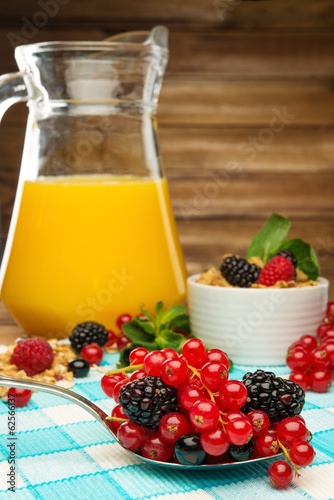 Healthy breakfast with fresh orange juice on tablecloth 