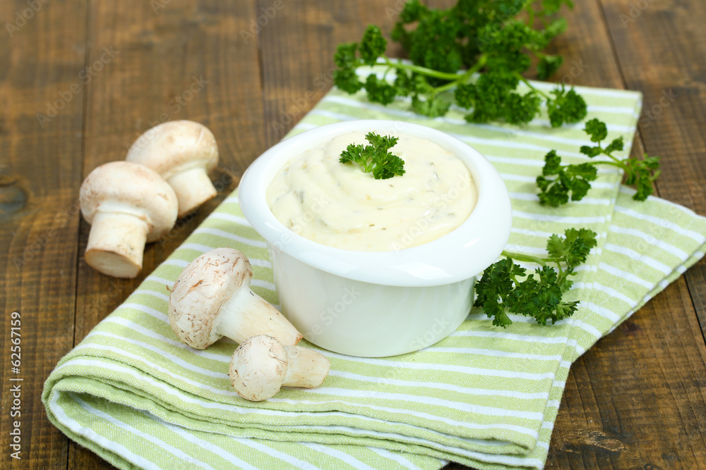 Delicate mushroom sauce in bowl on wooden table close-up Delicate mushroom sauce in bowl on wooden table close-up