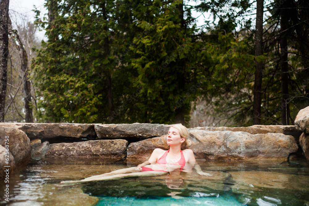 Fototapeta premium Young Woman Relaxing in a Nordic Spa